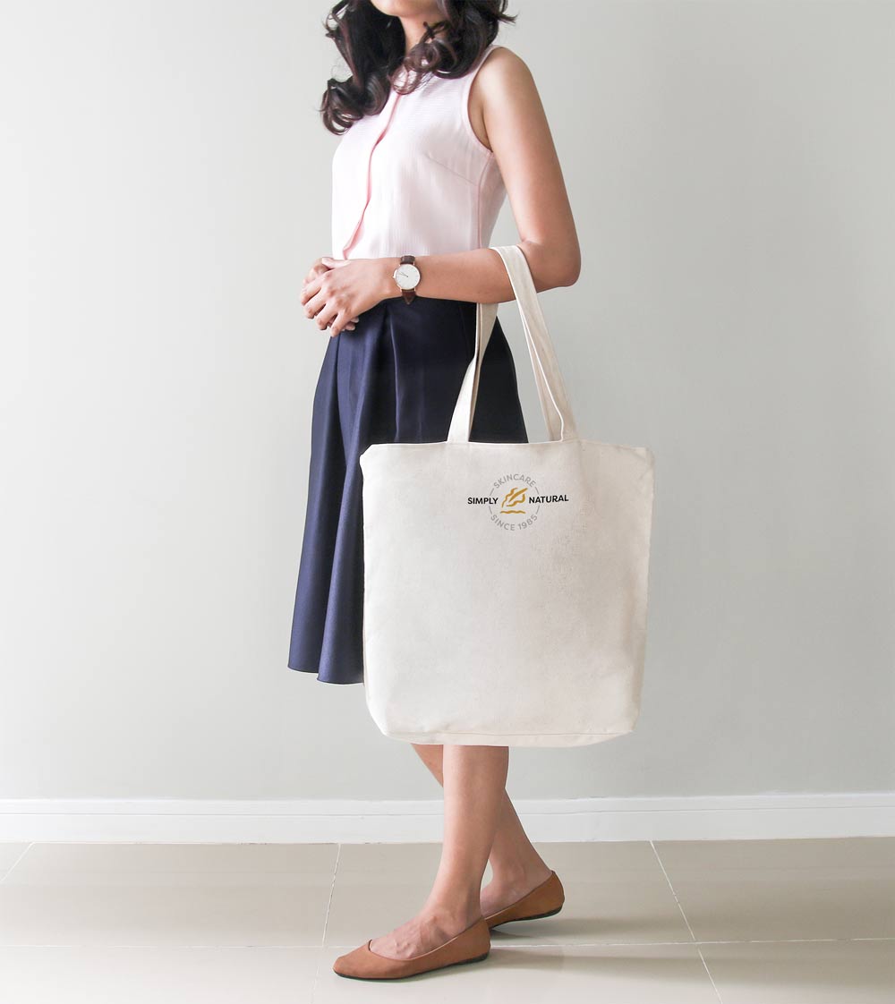 girl holding a Simply Natural tote bag